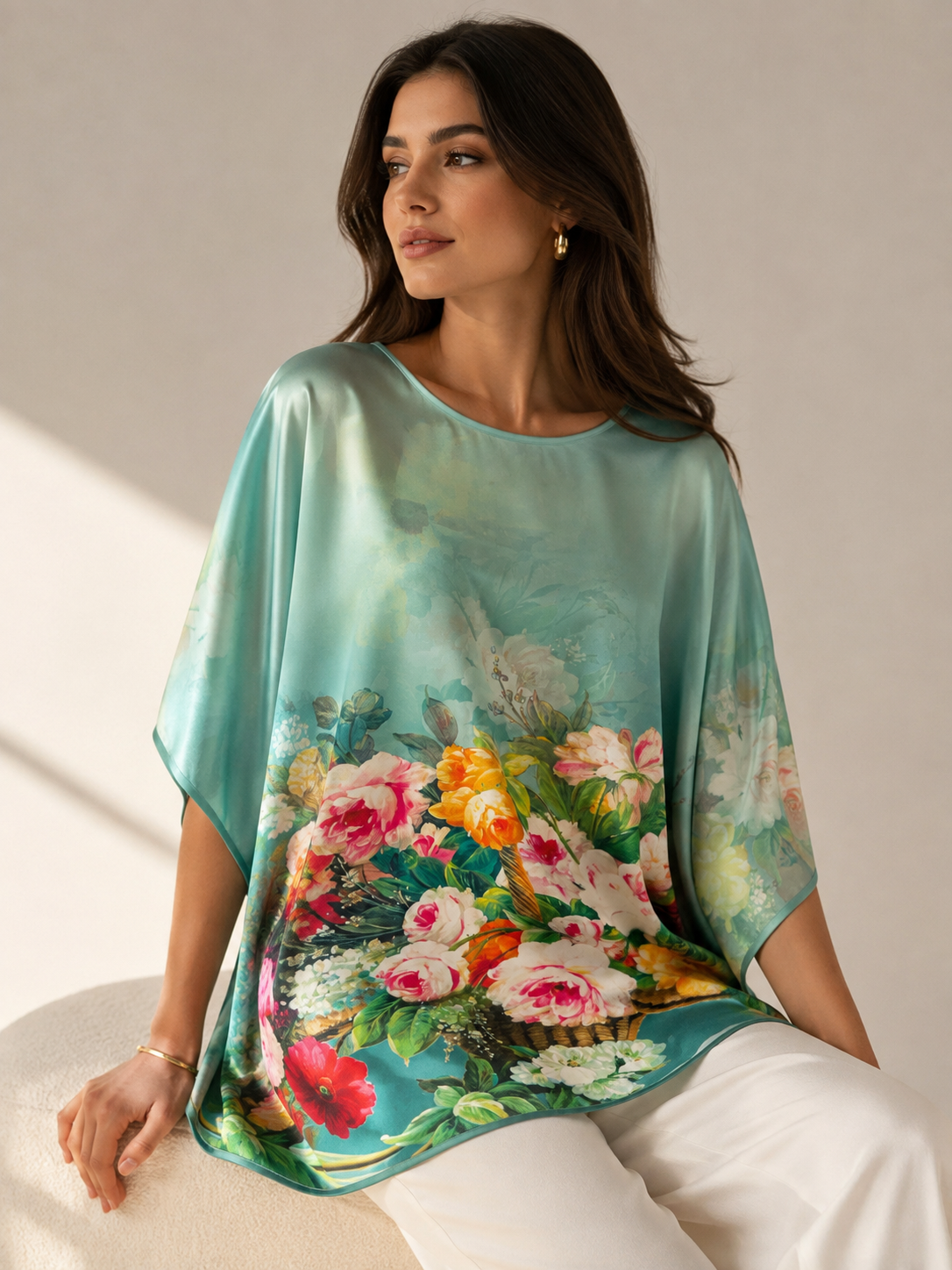 "Printed silk tunic with bold blue floral and leaf print — relaxed batwing fit, editorial lifestyle shot"