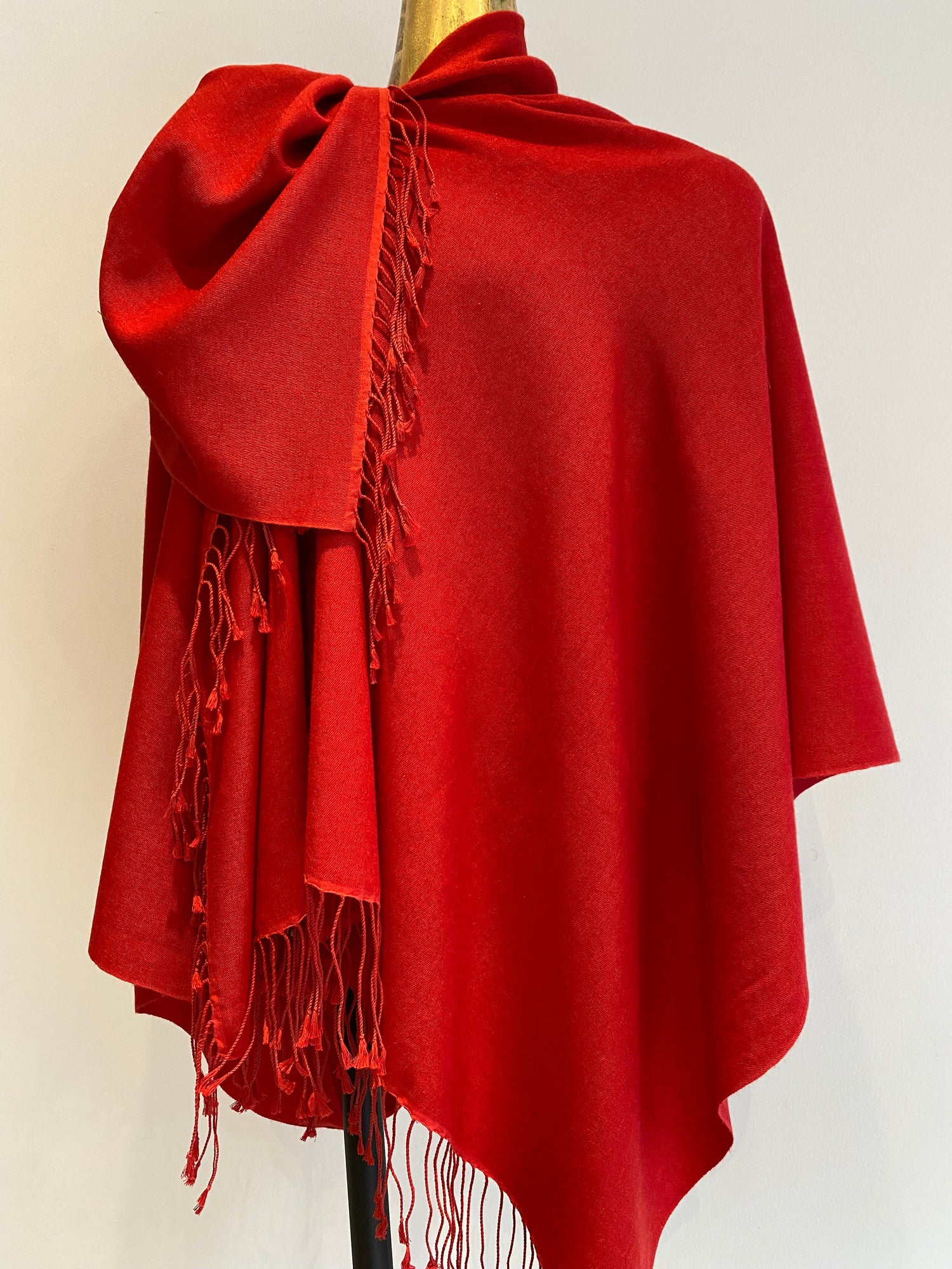 A red pashmina shawl with a lovely drape