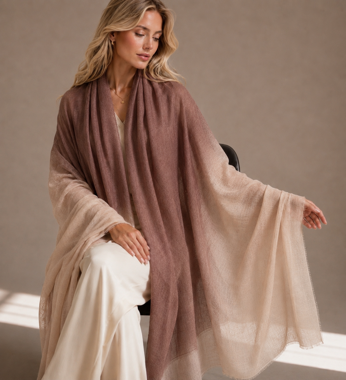 Cashmere two tone shawl draped elegantly over the shoulders of a model sitting 