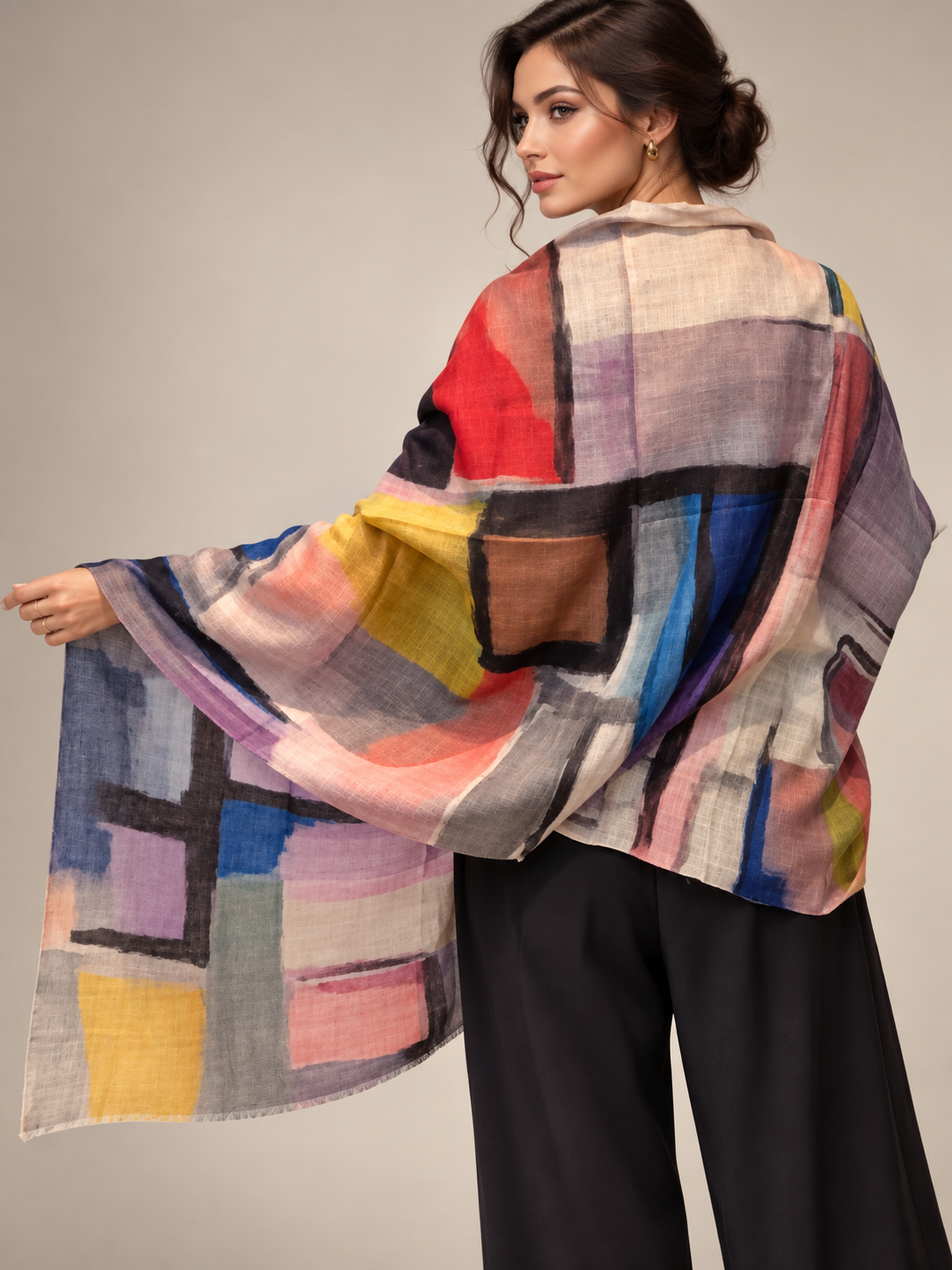 A graphic cashmere scarf worn by a model