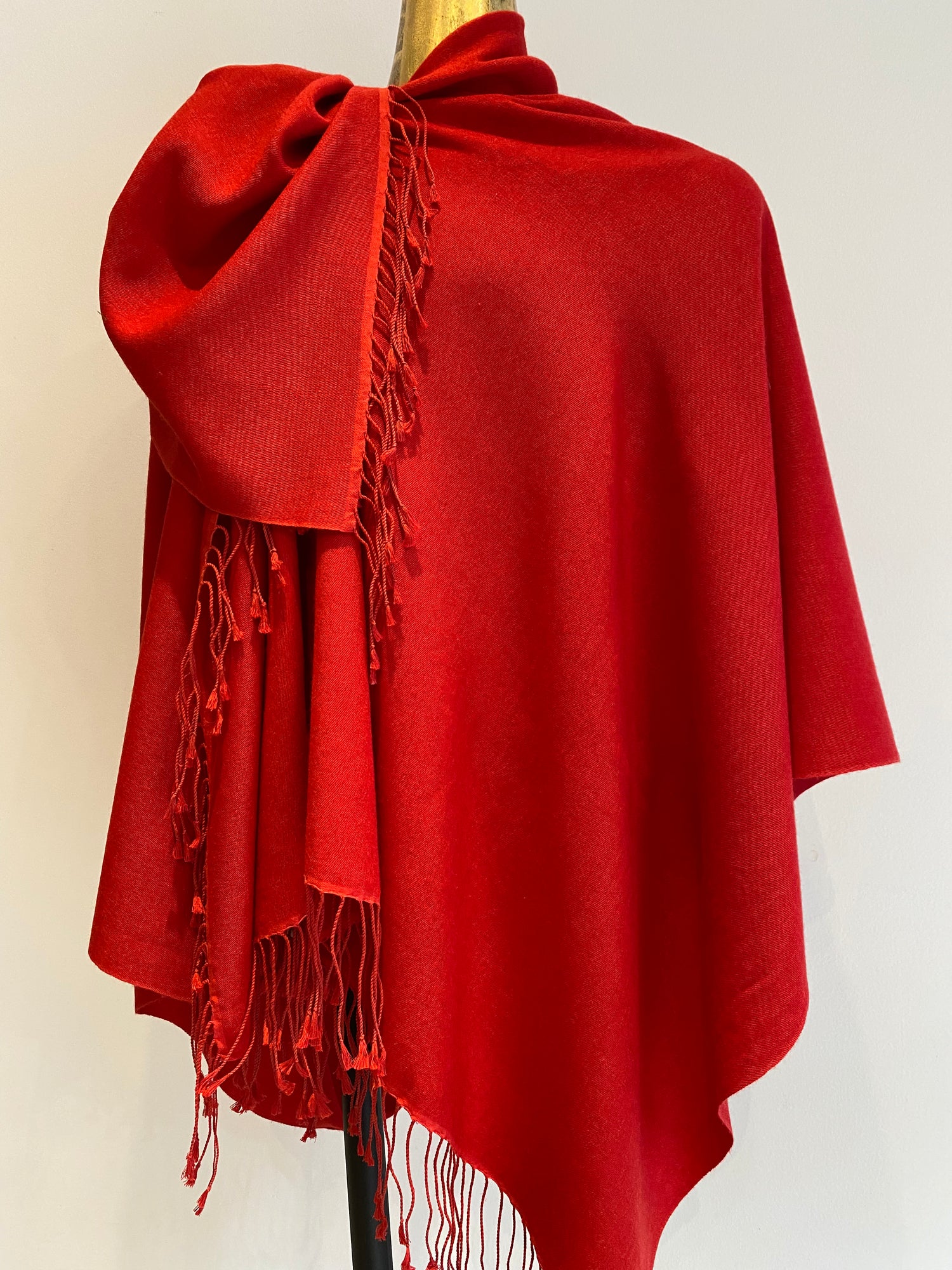 A red pashmina shawl with a lovely drape