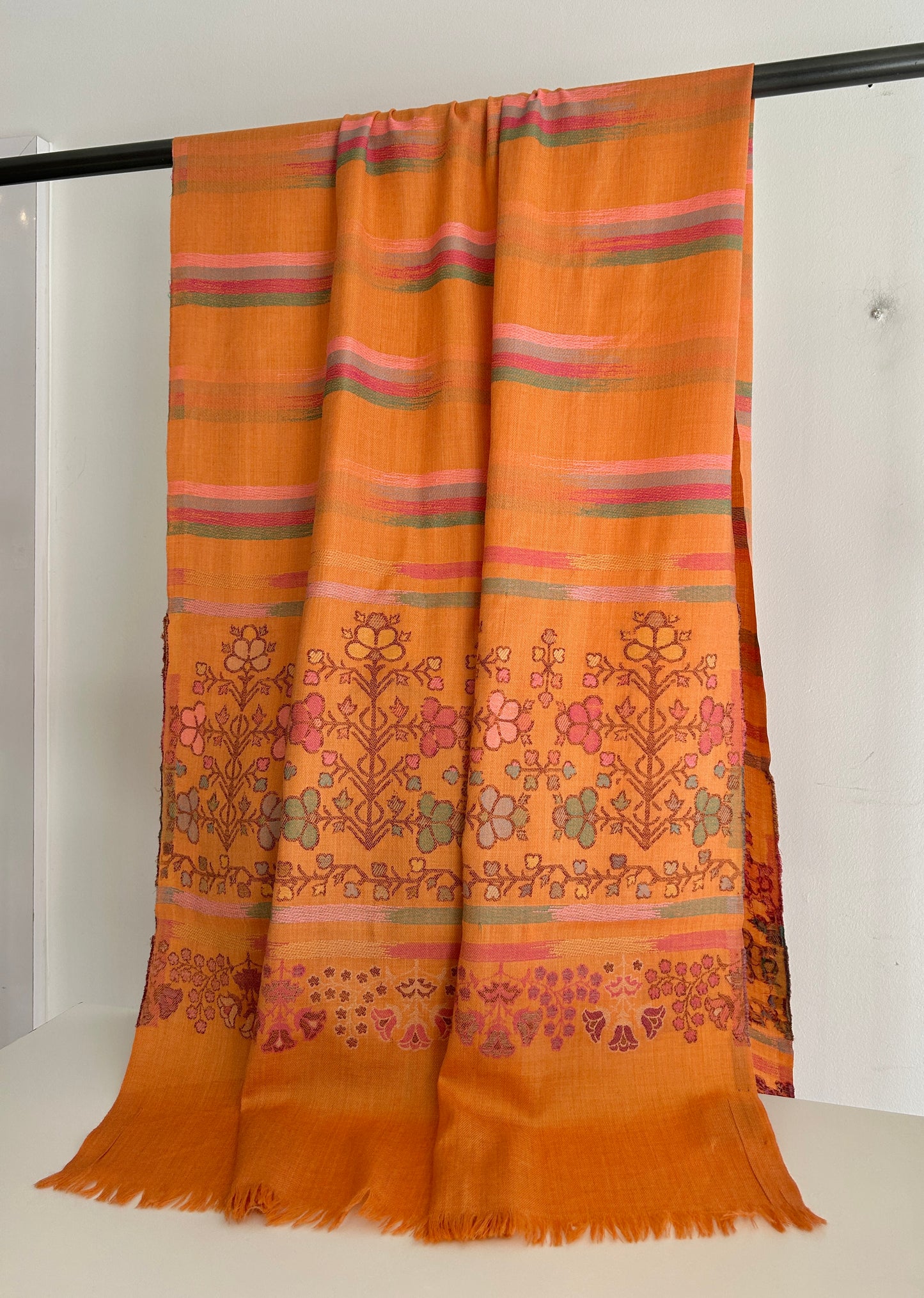 Beautiful shades all woven together in this light wool shawl