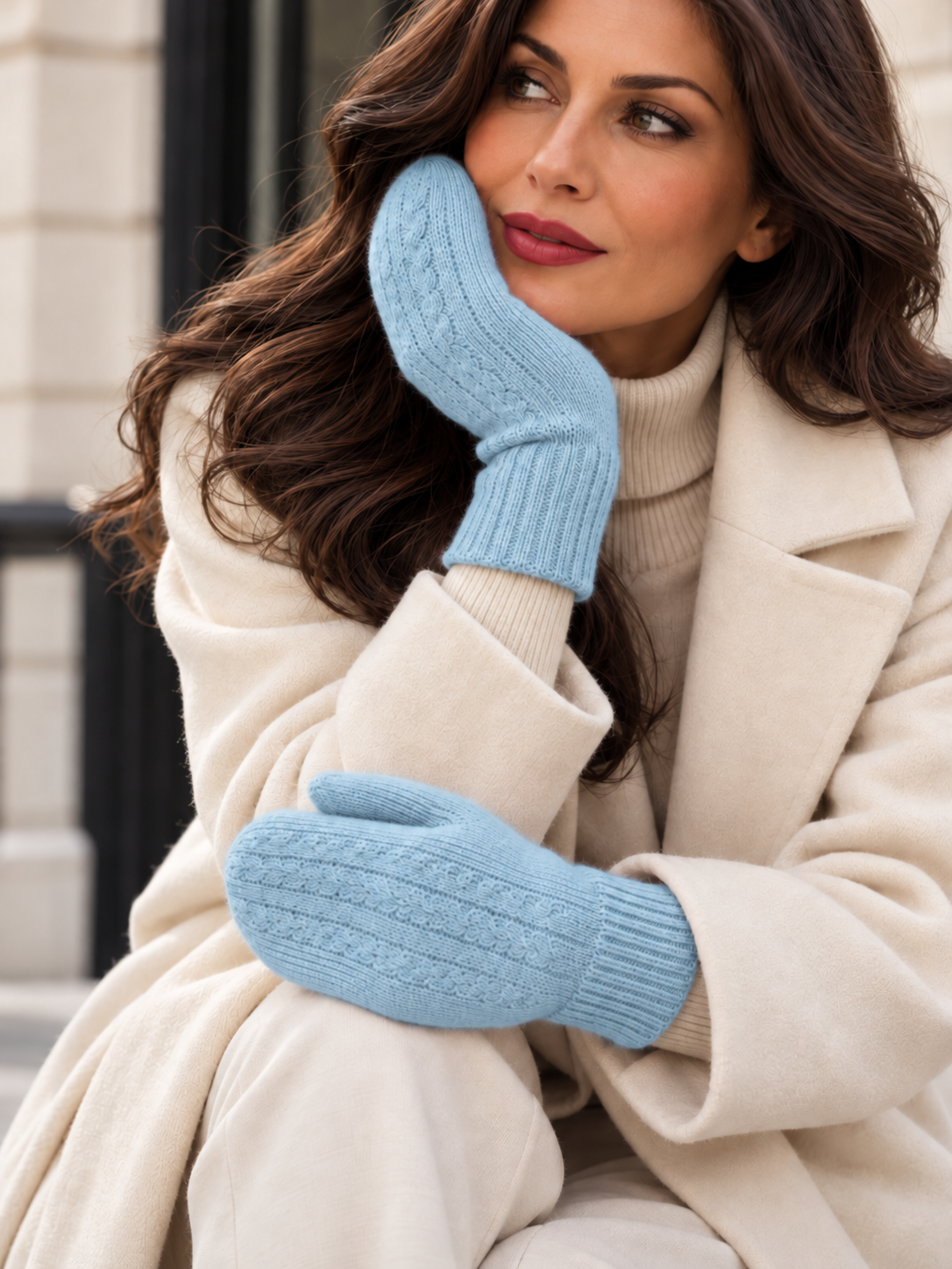 Model wears blue cashmere mittens