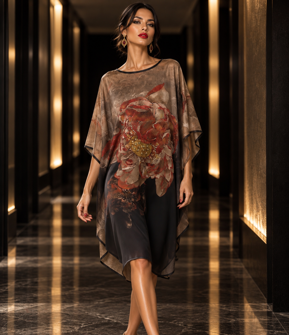 A woman walks down a luxury hallway wearing a sheer, draped tunic dress with a large red and gold floral print over a black underlayer.